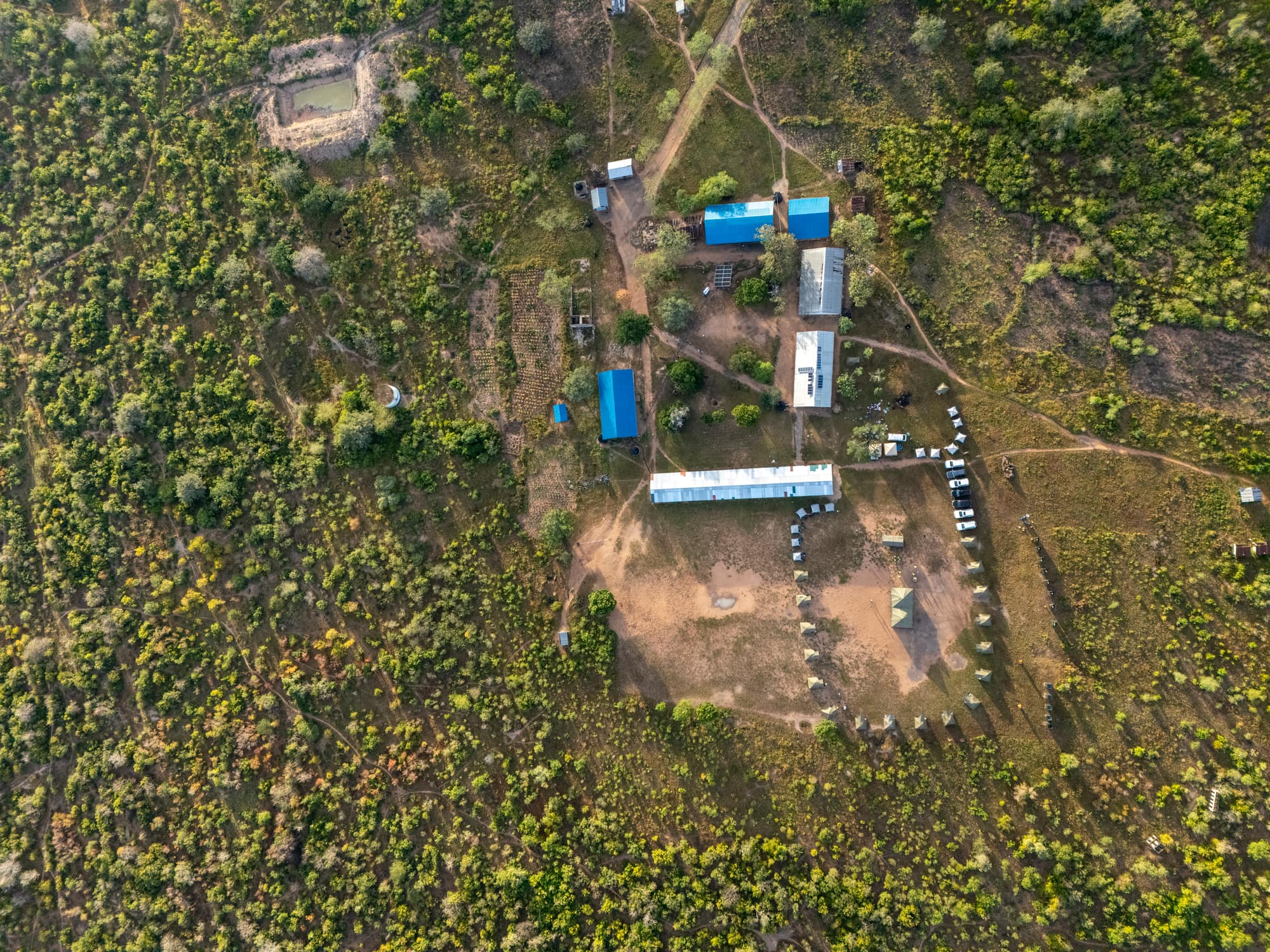 Aerial view of the school compound and surrounding bushland at a trek install site in Kenya