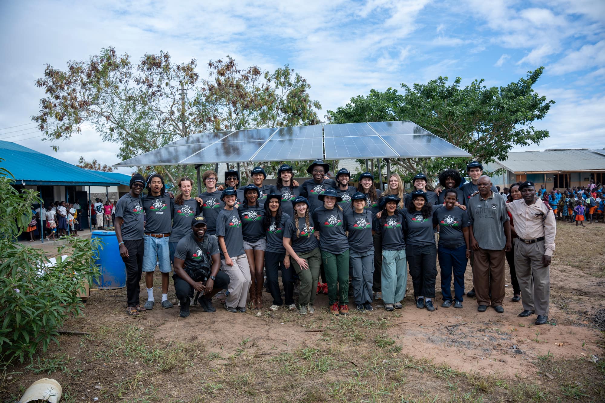 The UT GivePower trek team in matching Trek shirts at a school in Kenya